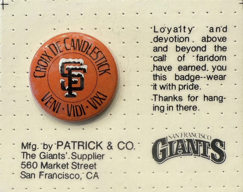 The original Croix de Candlestick pin, orange enamel with the SF logo at center